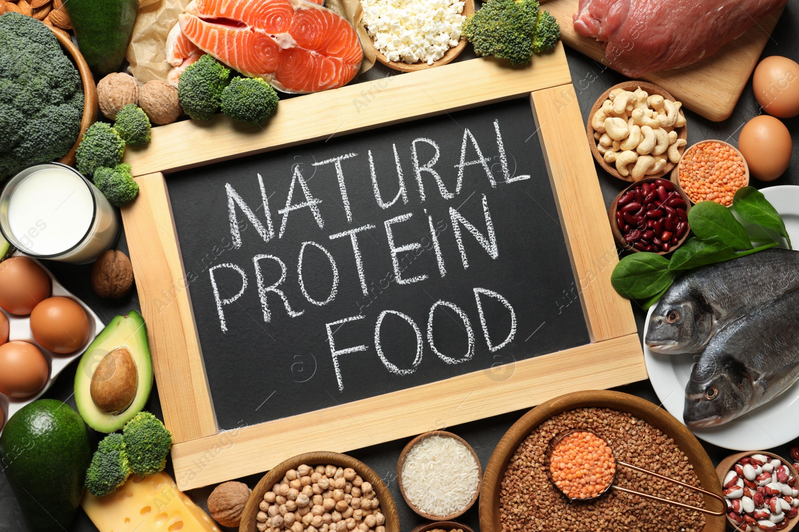 Photo of Chalkboard with written text Natural Protein Food among products, top view