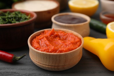 Photo of Fresh marinade in bowl on grey wooden table, closeup