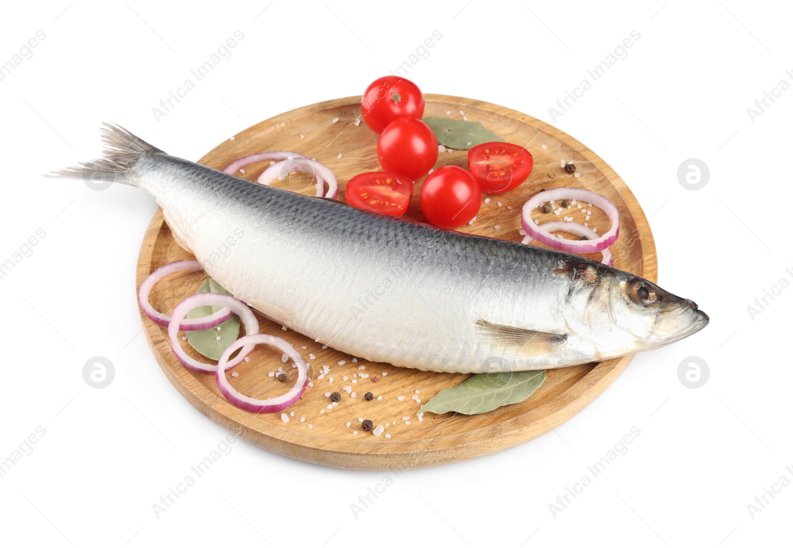 Photo of Wooden tray with salted herring, cherry tomatoes, bay leaves, onion rings and peppercorns isolated on white