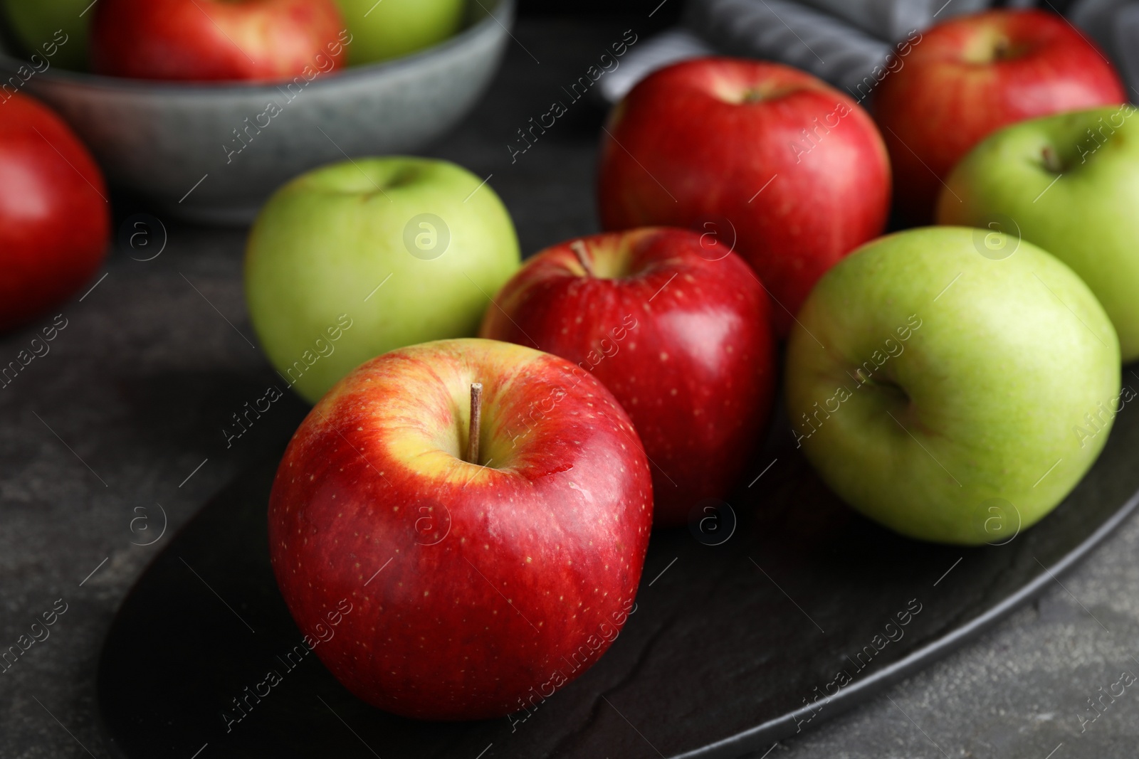 Photo of Fresh ripe green apples on black table, closeup