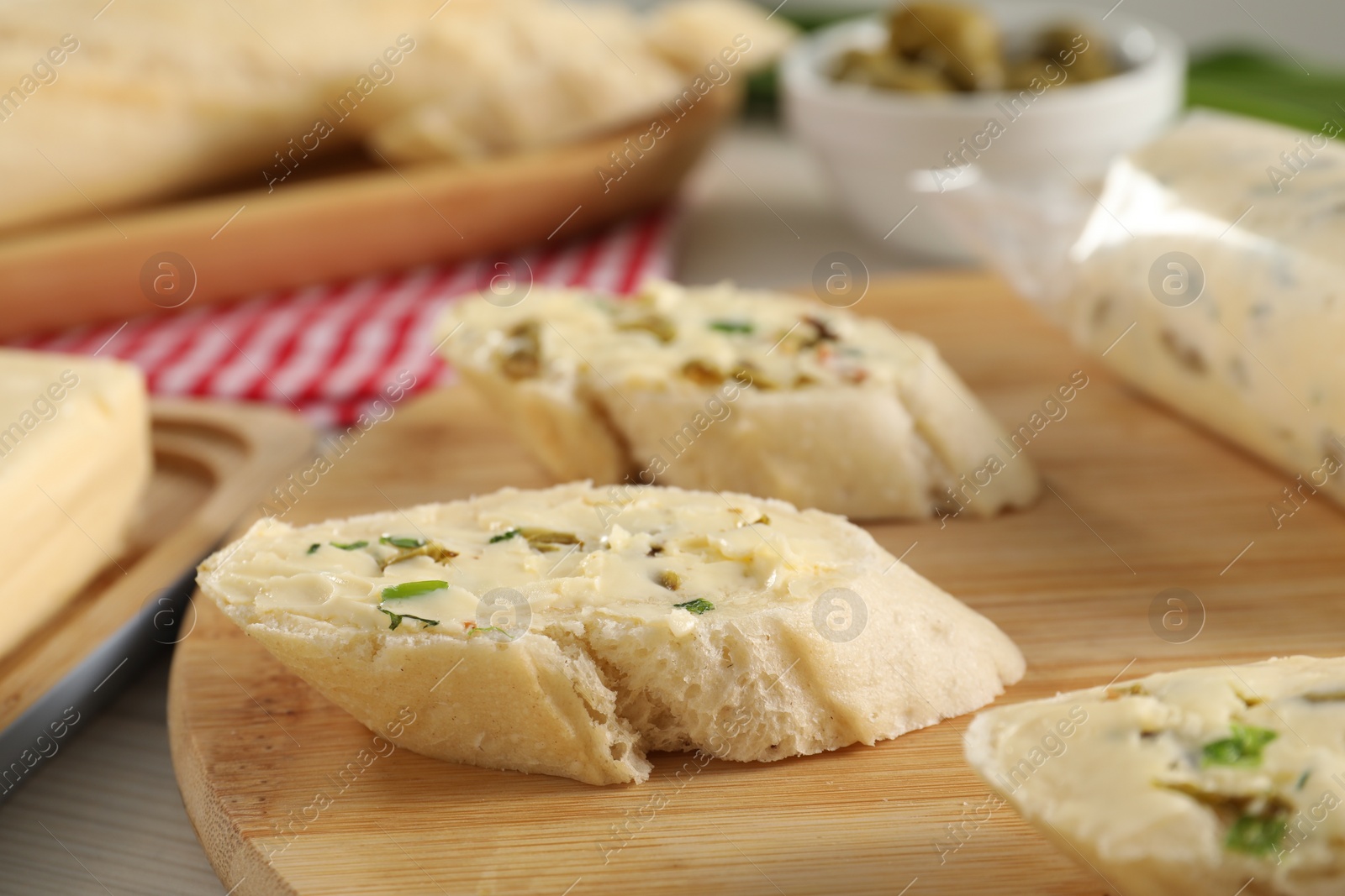 Photo of Tasty butter with spices and bread on table, closeup