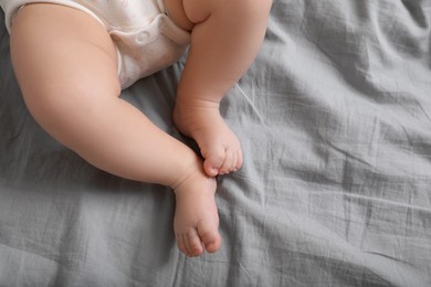 Little baby on bed, top view. Space for text