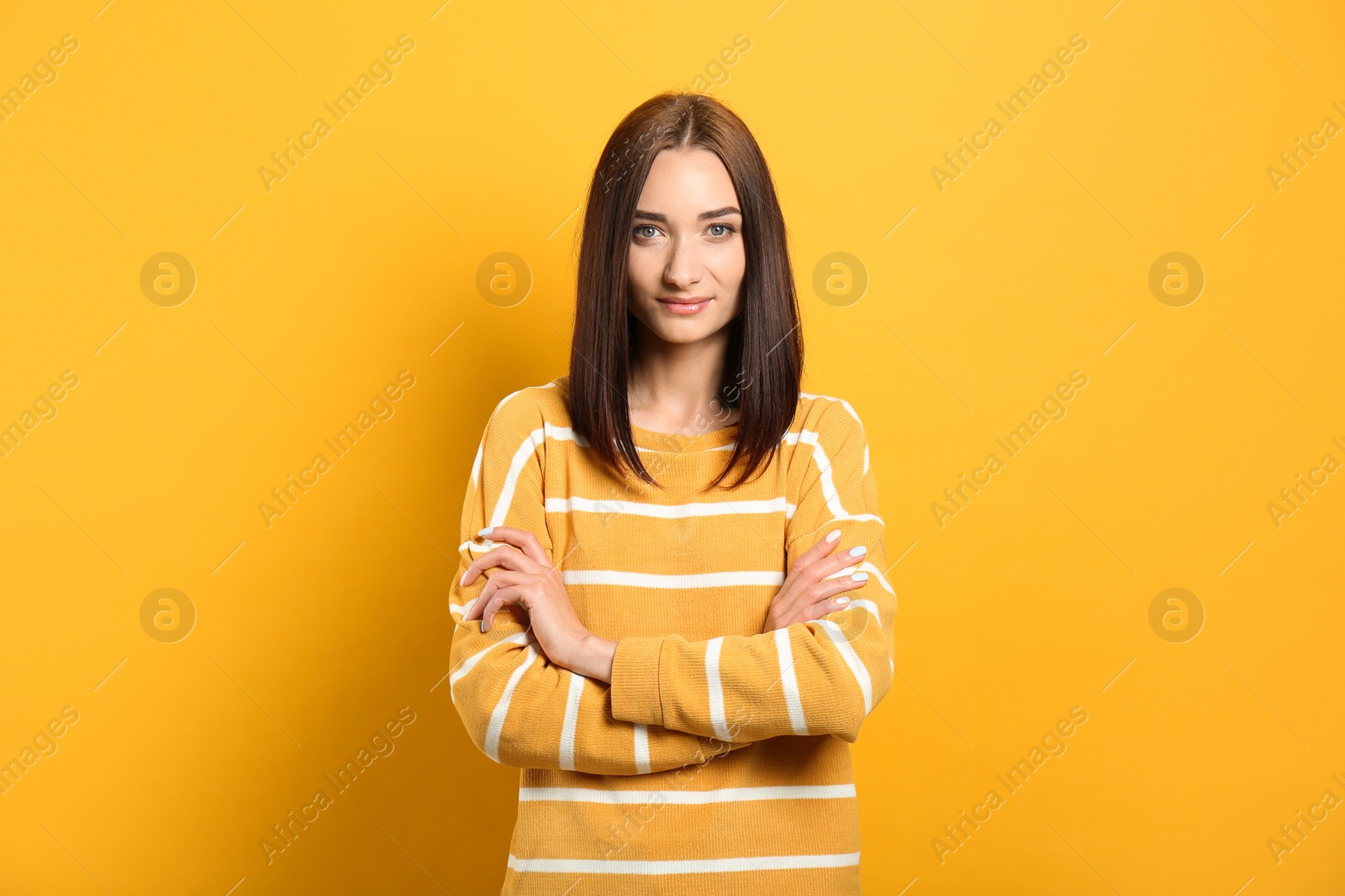 Photo of Portrait of pretty young woman with gorgeous chestnut hair on yellow background