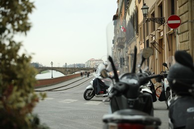 Beautiful view of city street with bridge, buildings and motorbikes