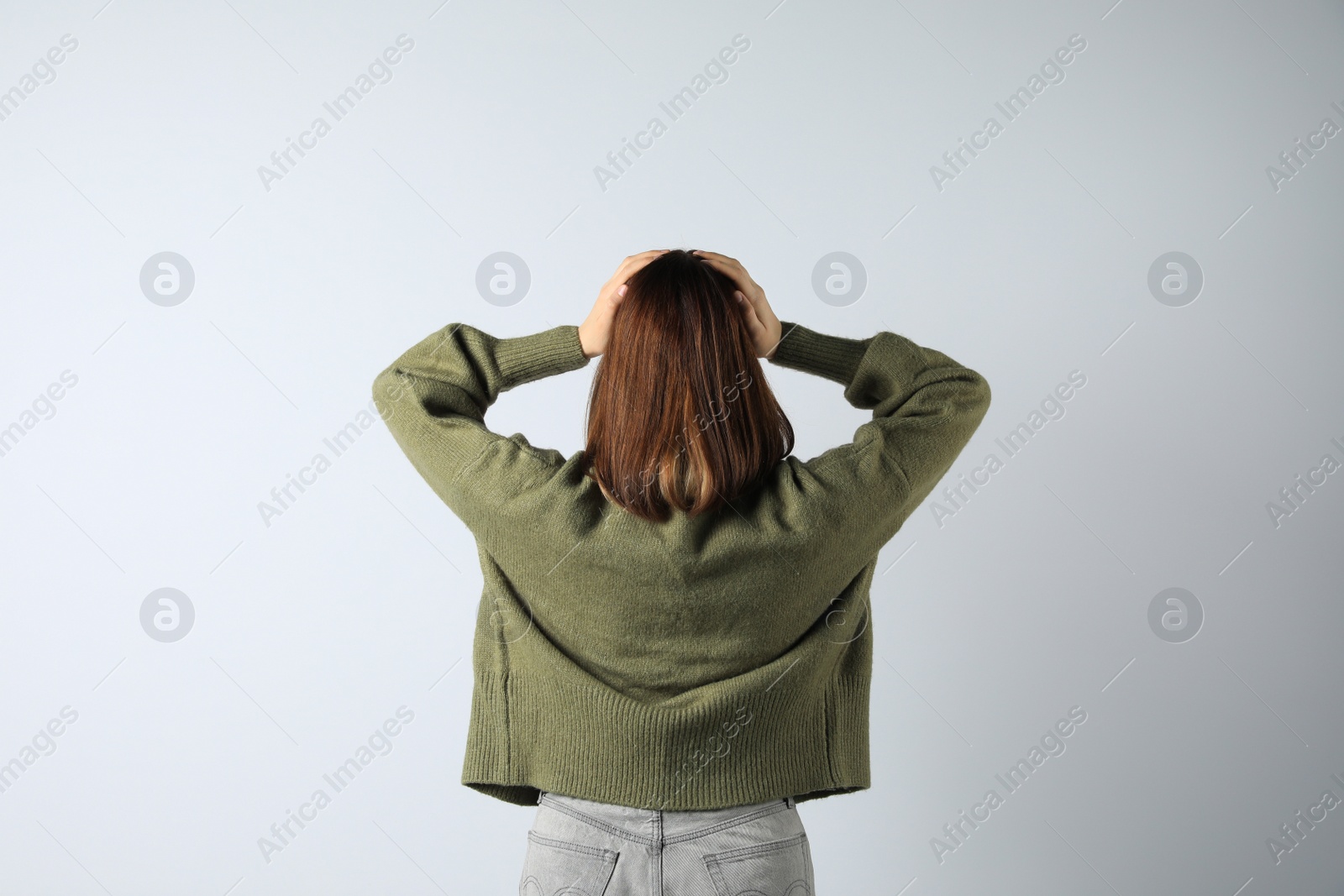 Photo of Girl wearing cardigan on white background, back view