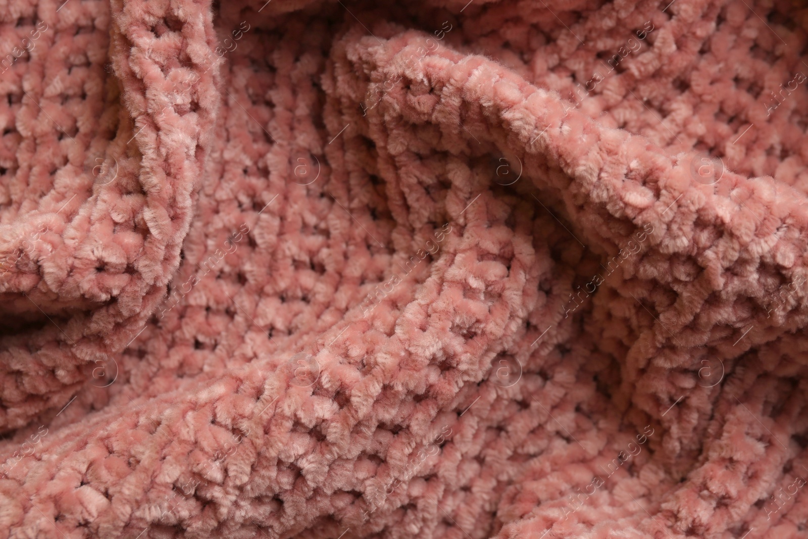 Photo of Beautiful pink knitted fabric as background, closeup