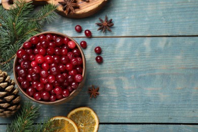 Photo of Flat lay composition with fresh ripe cranberries on blue wooden table. Space for text