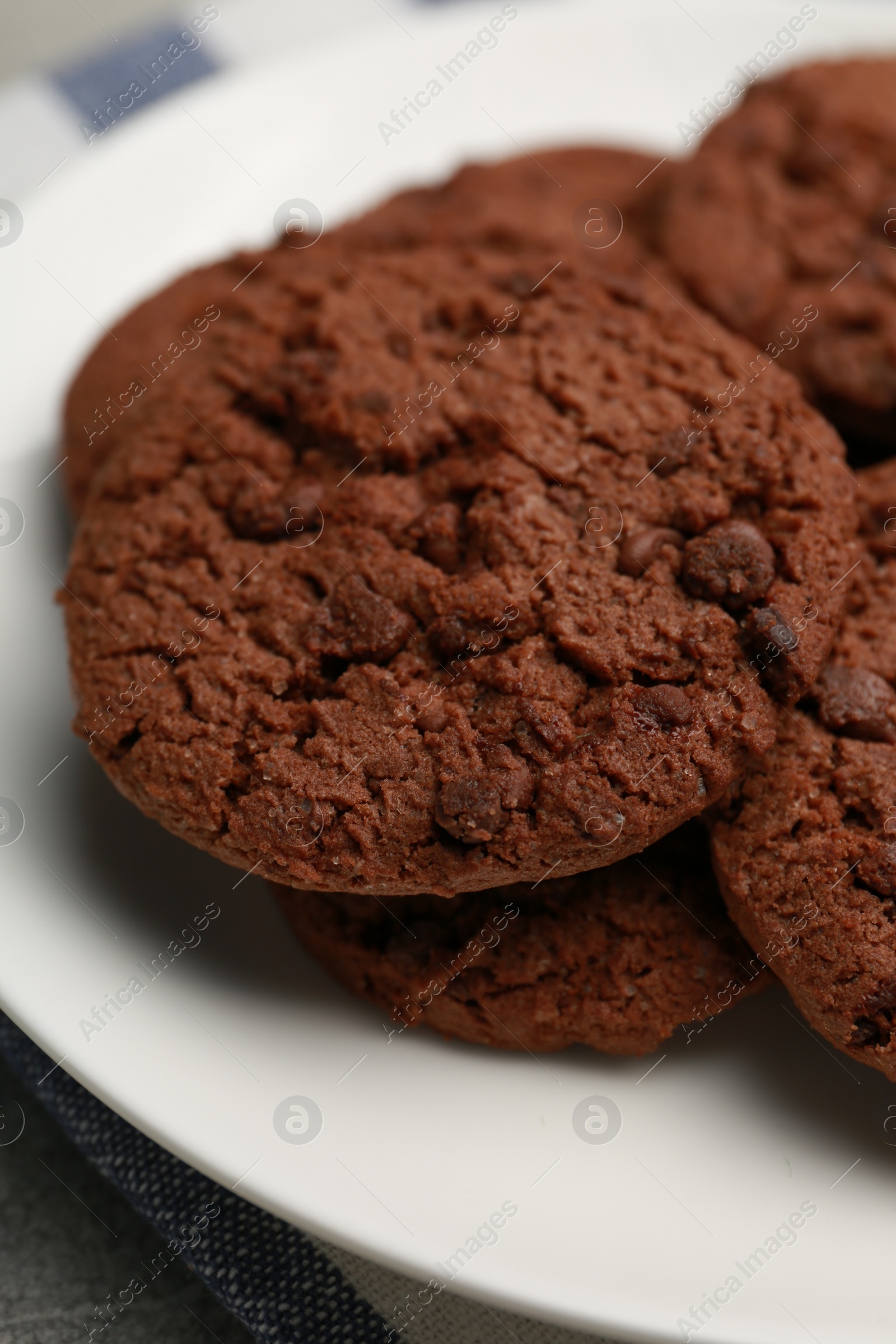 Photo of Delicious chocolate chip cookies on plate, closeup