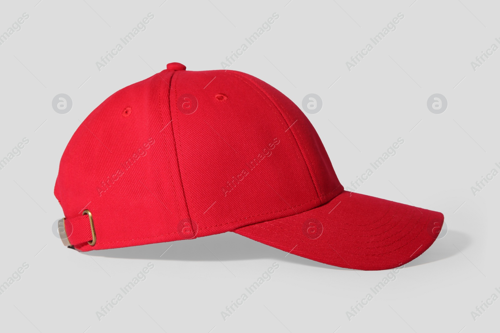 Photo of Stylish red baseball cap on white background