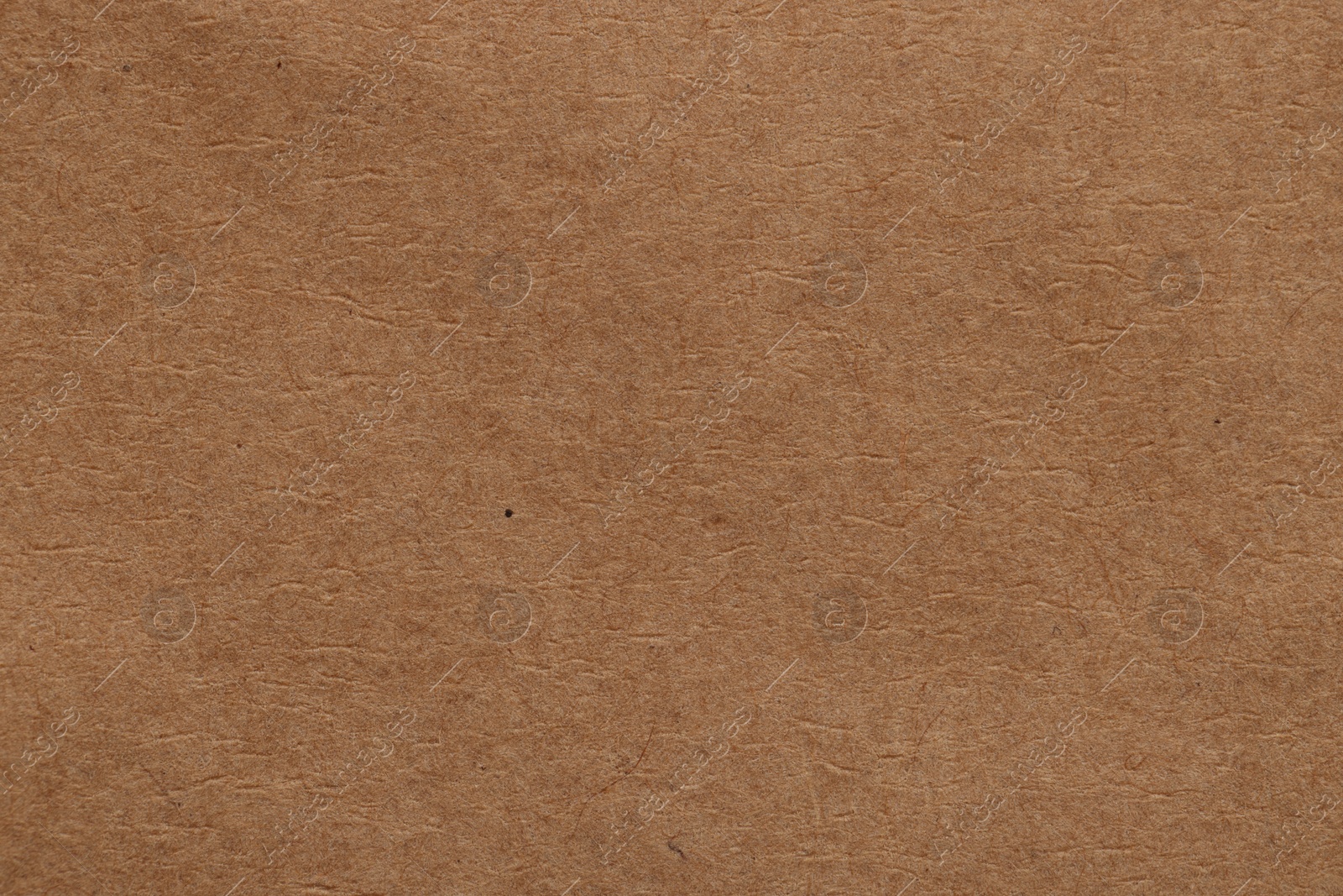 Photo of Texture of brown paper sheet as background, top view