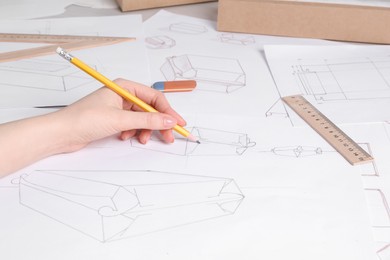 Photo of Woman creating packaging design at table, closeup