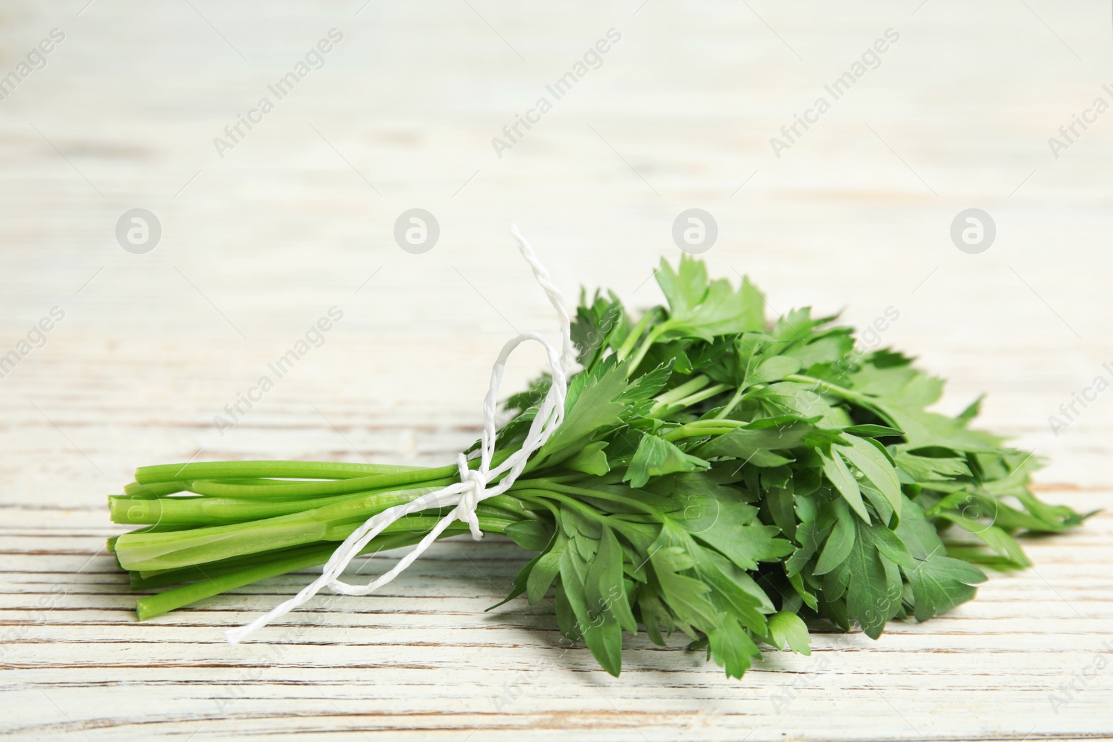 Photo of Bunch of fresh green parsley on wooden background. Space for text