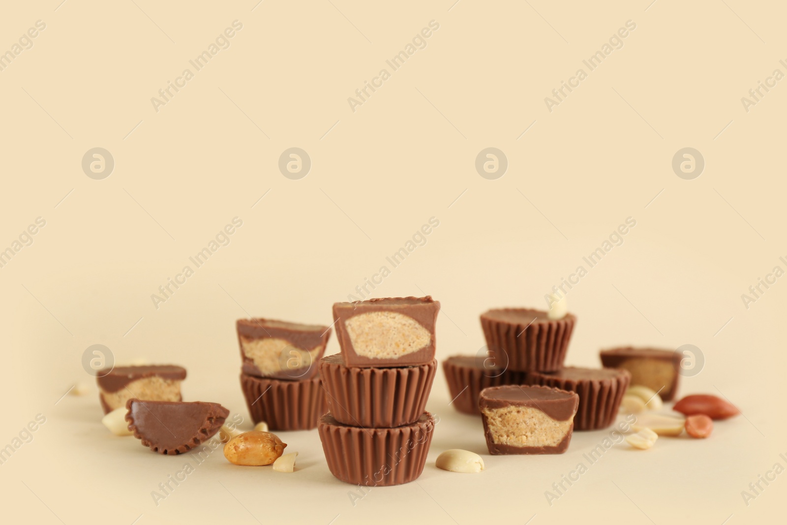 Photo of Sweet peanut butter cups on beige background