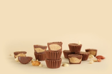 Photo of Sweet peanut butter cups on beige background