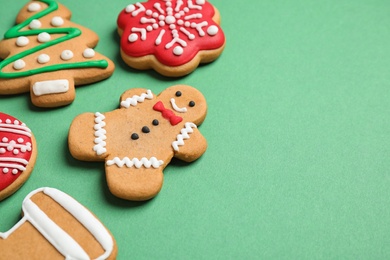 Photo of Tasty homemade Christmas cookies on green background, space for text