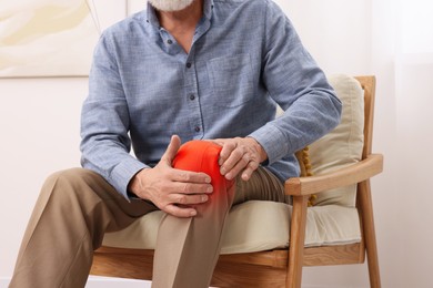 Image of Man suffering from rheumatism in knee at home, closeup