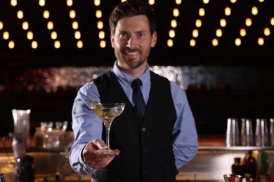 Photo of Bartender with fresh alcoholic cocktail in bar, selective focus