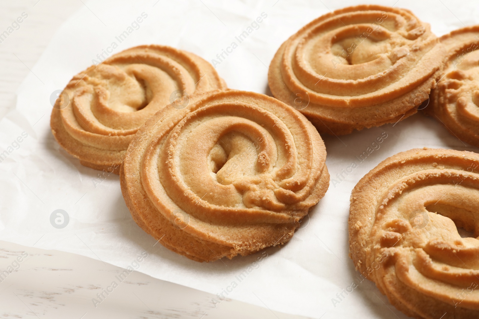 Photo of Danish butter cookies on wooden table, closeup