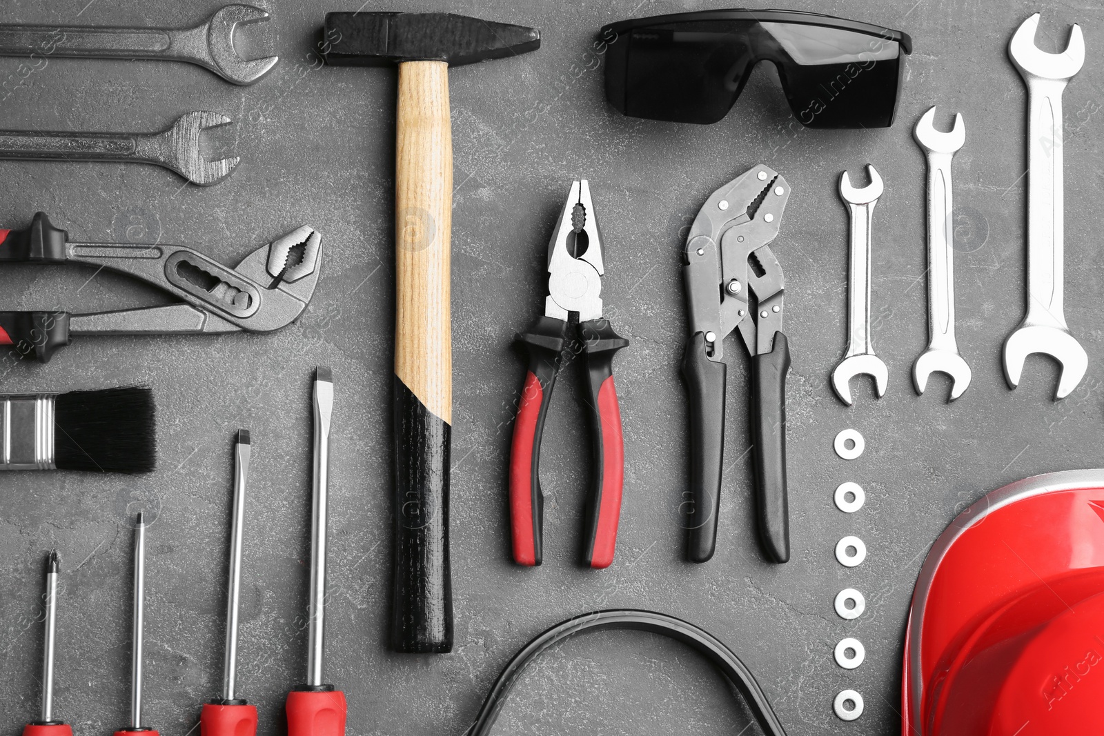 Photo of Flat lay composition with different construction tools on grey background