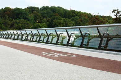 Modern bridge with bike lane over river