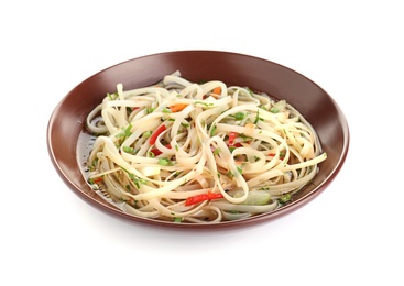 Plate of delicious noodles with broth and vegetables isolated on white