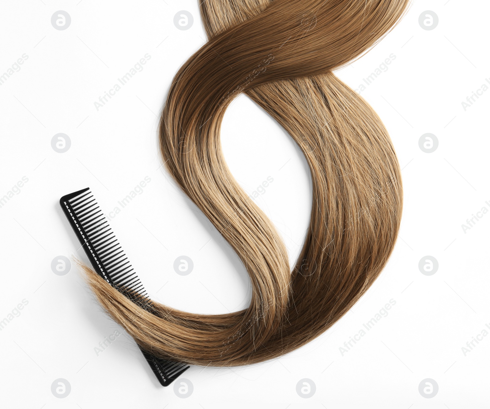 Photo of Beautiful strands of brown hair and comb on white background, top view. Hairdresser service