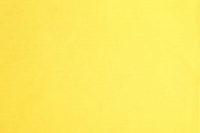 Texture of beautiful yellow fabric as background, closeup