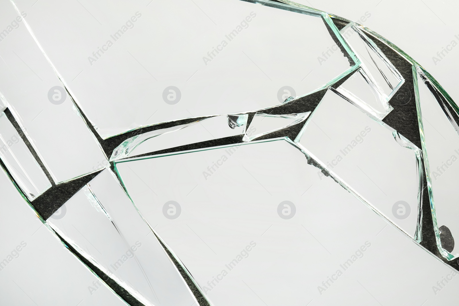 Photo of Shards of broken mirror on dark background, top view