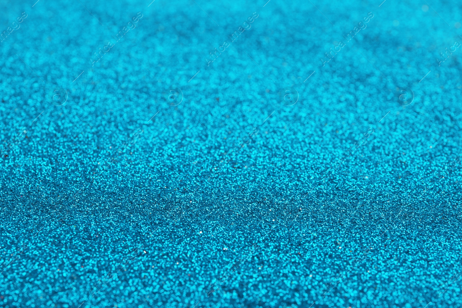 Photo of Closeup view of sparkling blue glitter background