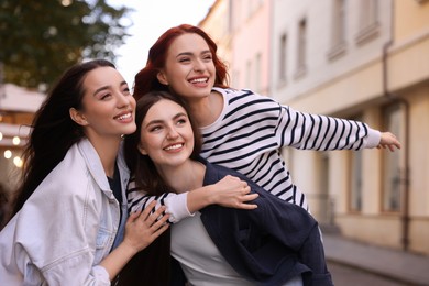 Happy friends spending time together on city street