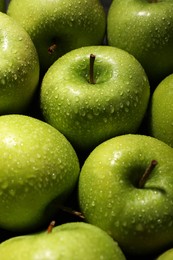 Photo of Ripe green apples with water drops as background, closeup