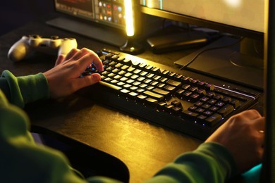 Photo of Man playing video games on computer indoors, closeup