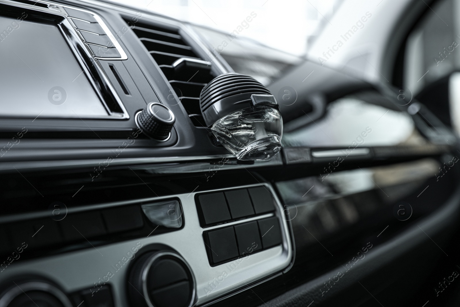 Photo of Stylish air freshener clip attached to car ventilation