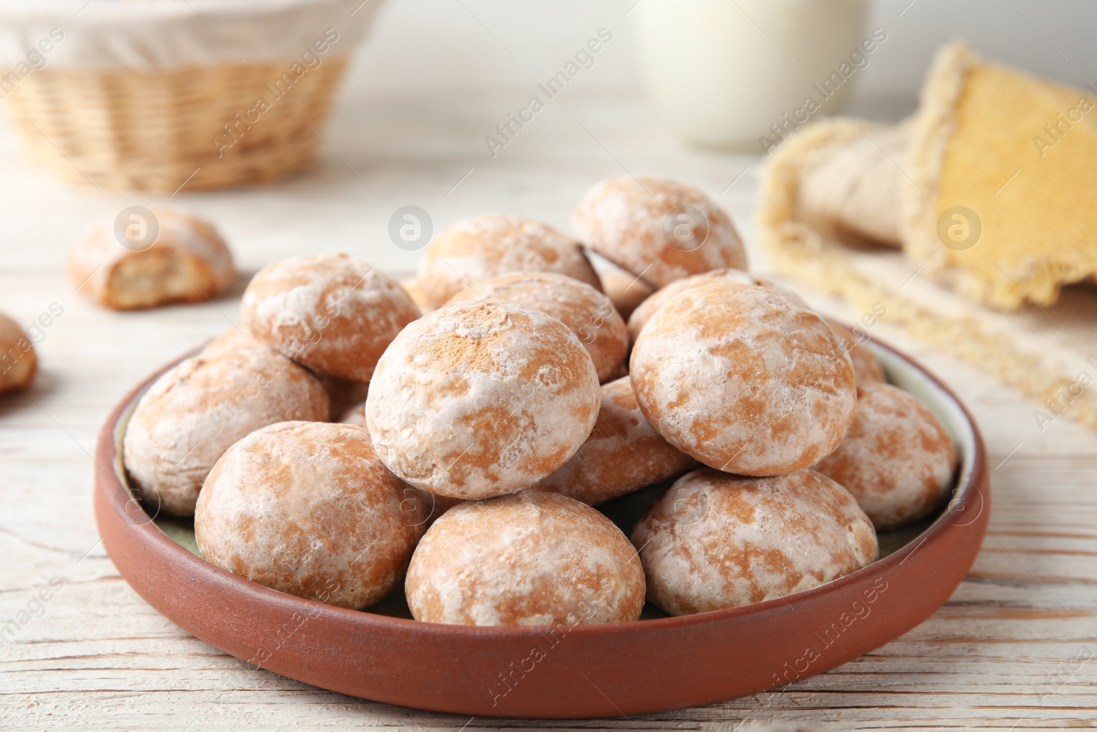 Photo of Plate with tasty homemade gingerbread cookies on white wooden table