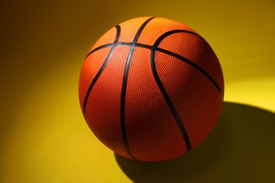 Photo of One new basketball ball on color background, closeup