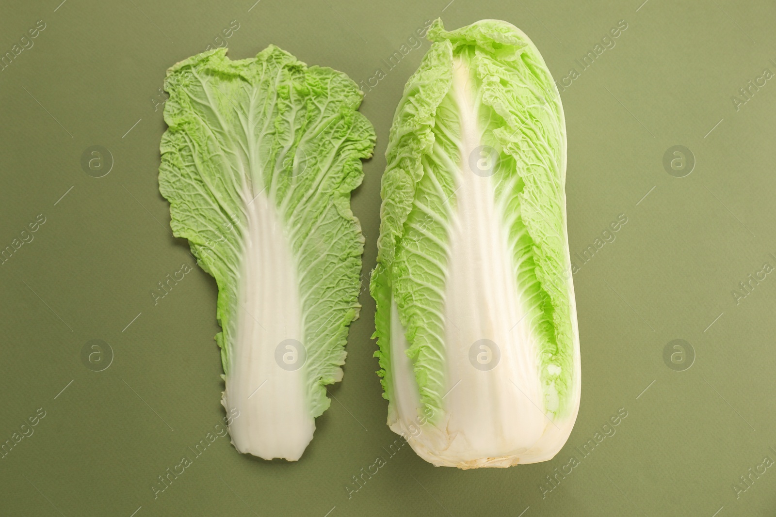 Photo of Fresh ripe Chinese cabbage and leaf on olive background, top view