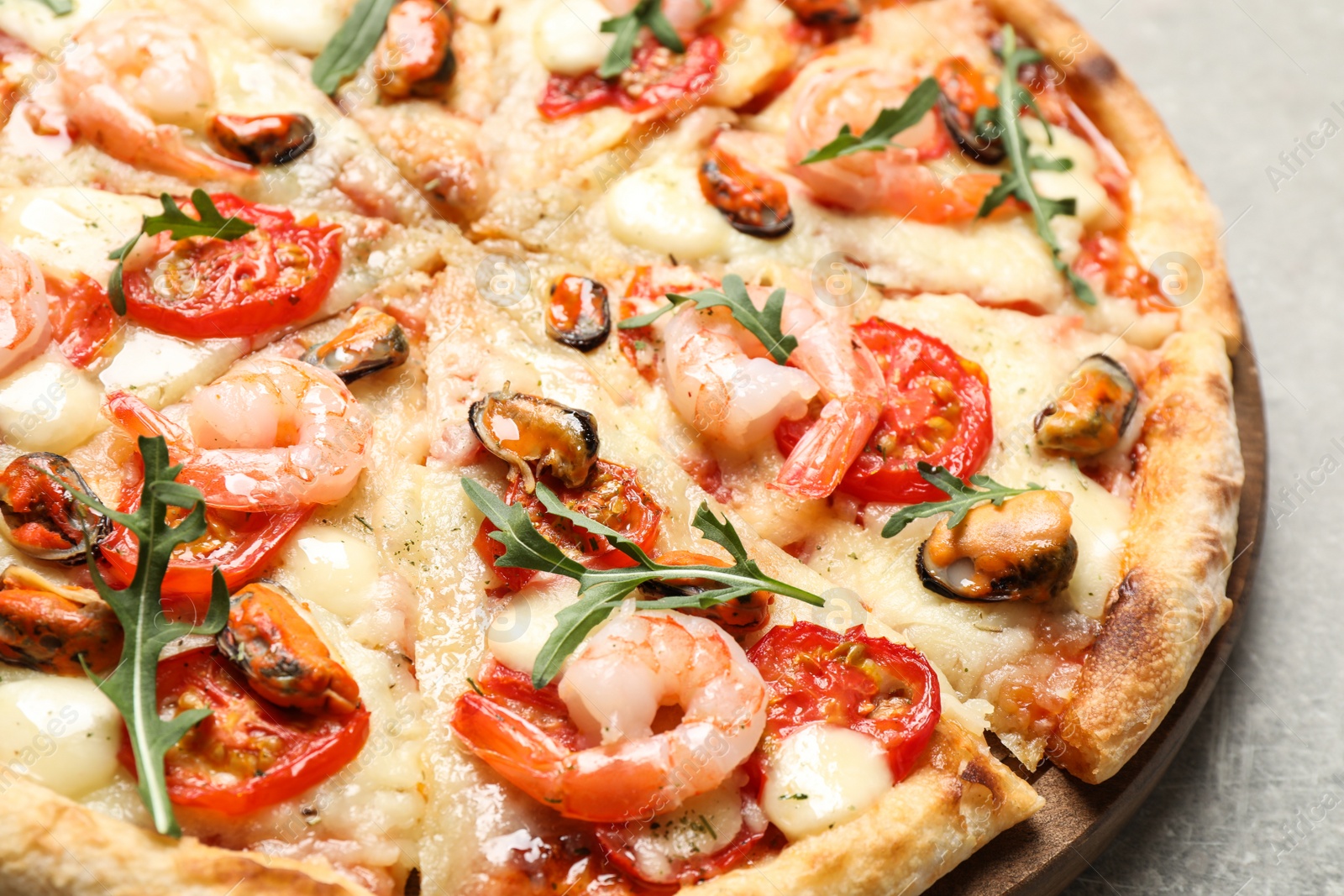 Photo of Delicious seafood pizza on table, closeup view