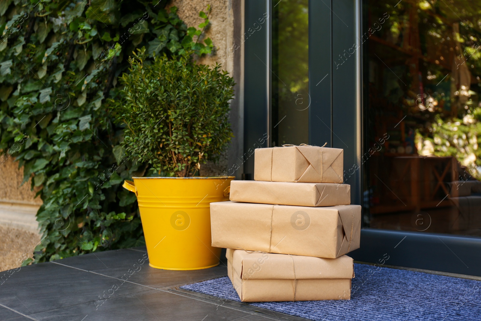 Photo of Delivered parcels on door mat near entrance