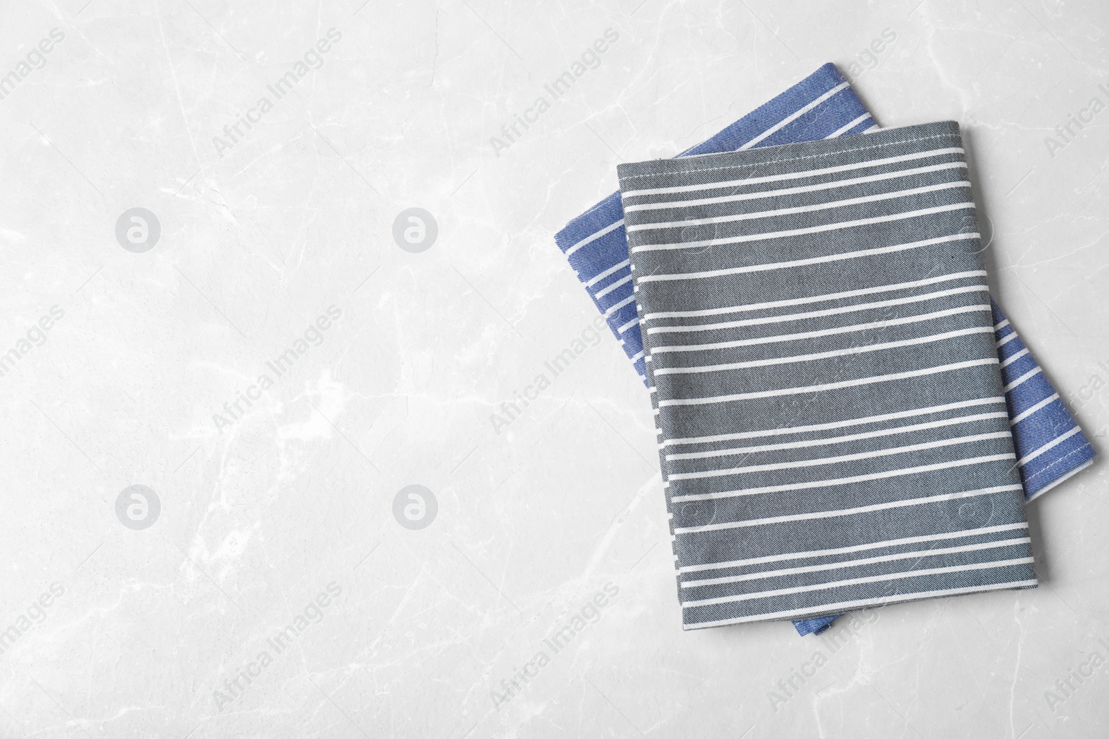 Photo of Fabric napkins and space for text on light background, top view