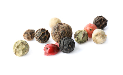 Mix of different pepper grains isolated on white