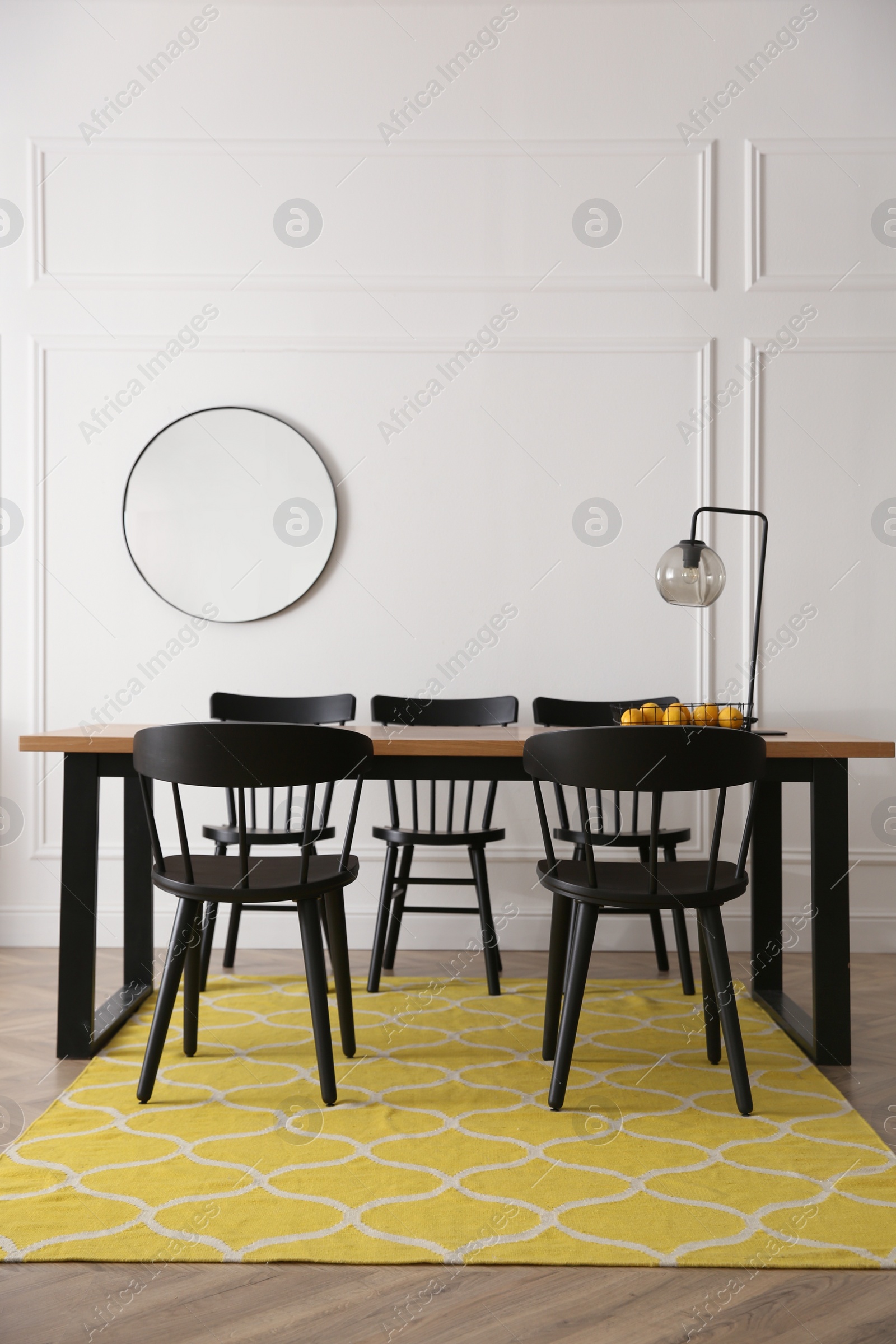 Photo of Stylish wooden dining table and chairs in room. Interior design