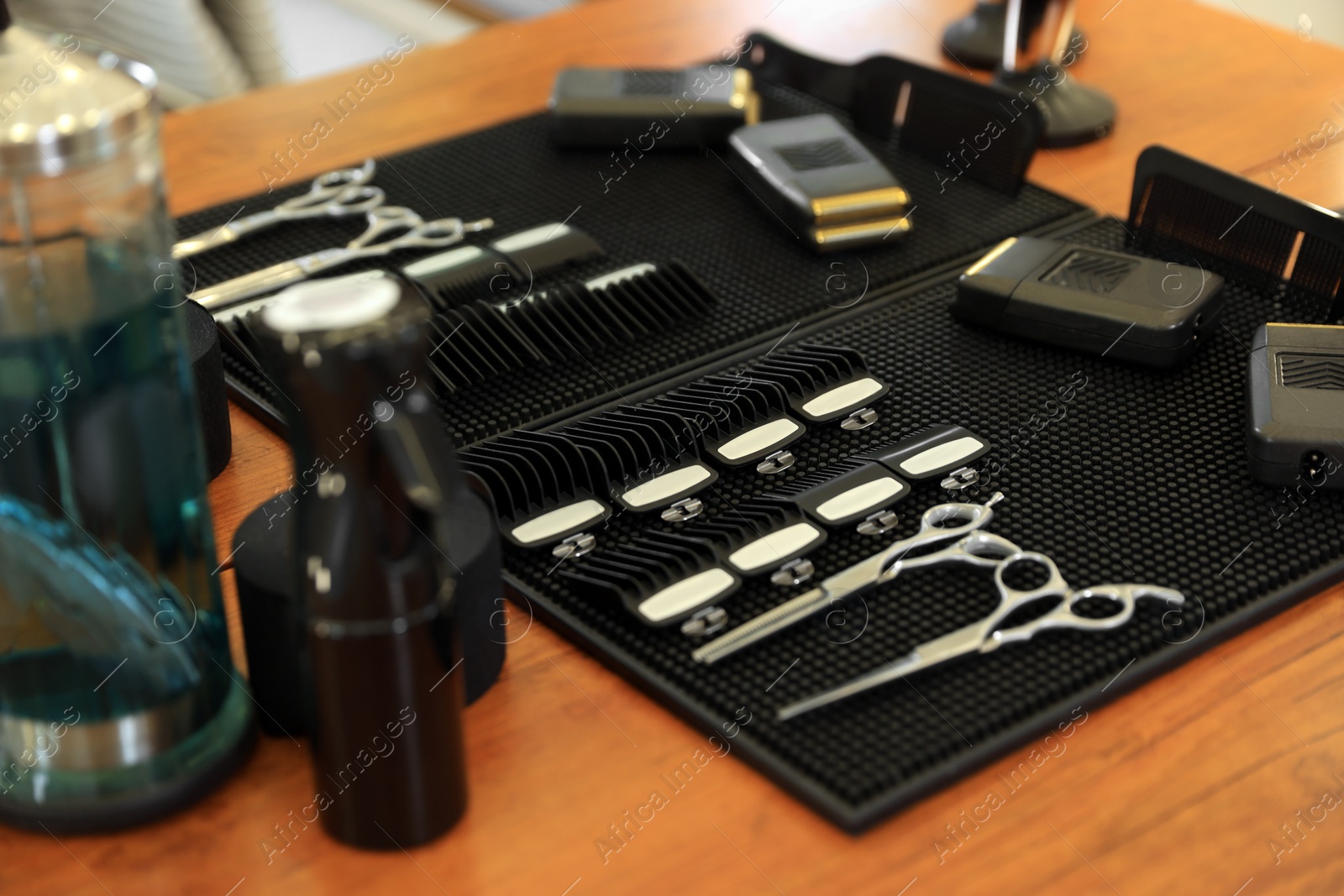 Photo of Stylish hairdresser's workplace with professional tools in barbershop, closeup