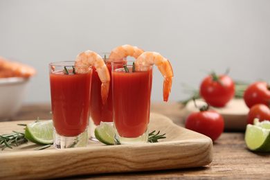 Photo of Shrimp cocktail with tomato sauce served on wooden table