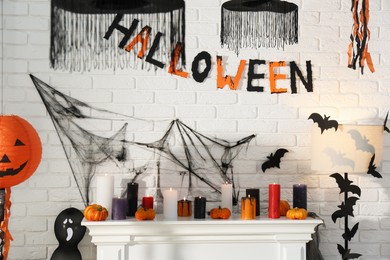 Fireplace with different Halloween decor indoors. Festive interior