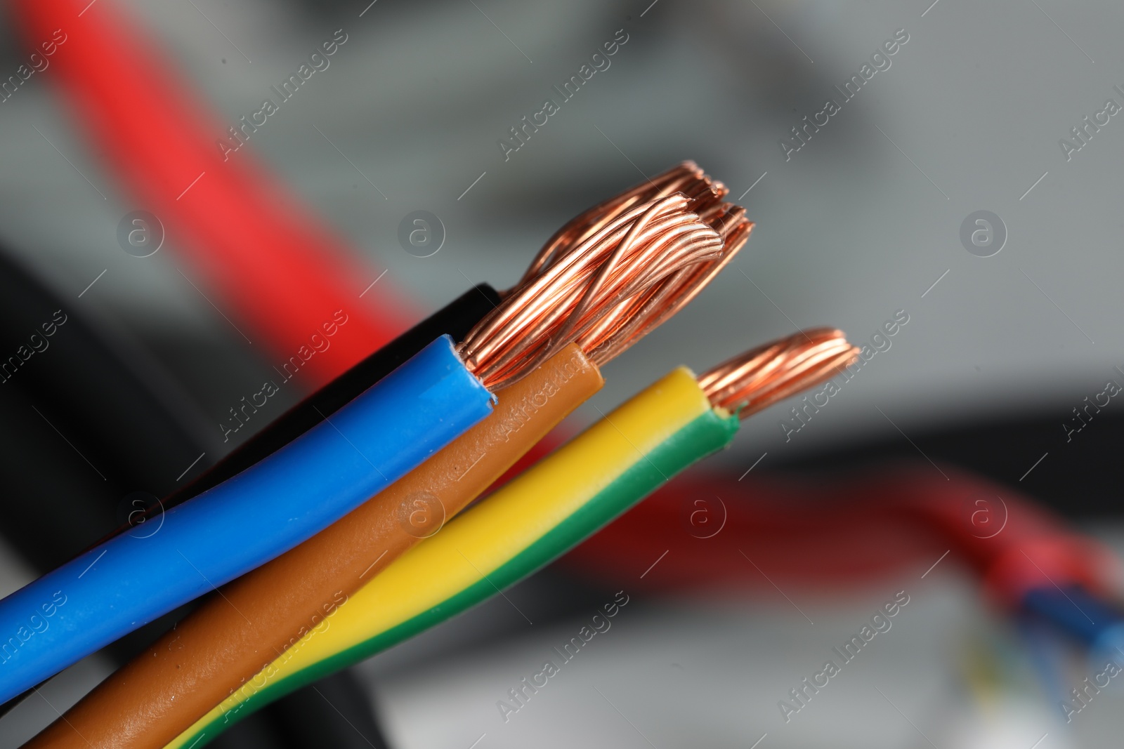 Photo of Colorful electrical wires on blurred background, closeup