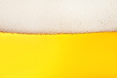 Photo of Glass of tasty beer with foam, closeup