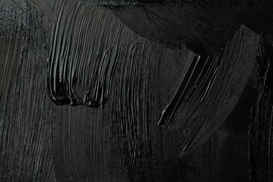 Beautiful strokes of black paint as background, closeup