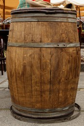 Photo of Traditional wooden barrel on city street outdoors