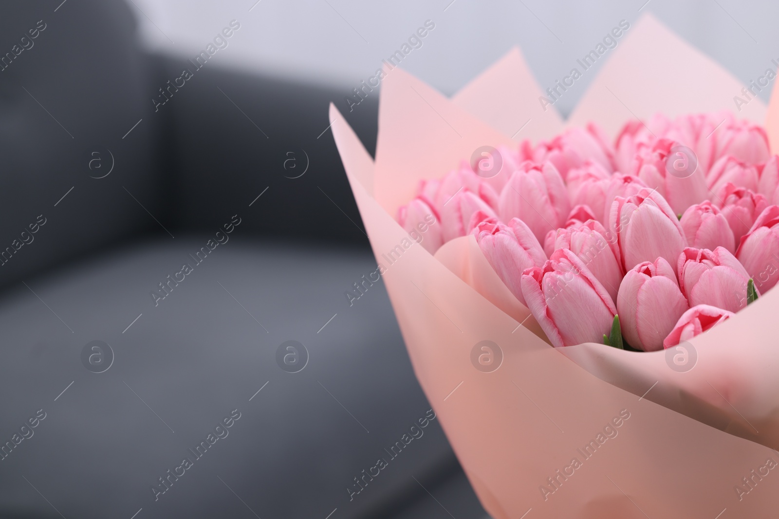 Photo of Bouquet of beautiful pink tulips indoors, closeup. Space for text