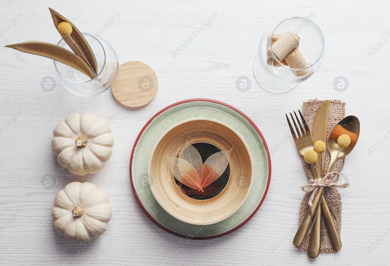 Photo of Autumn table setting with pumpkins on white wooden background, flat lay